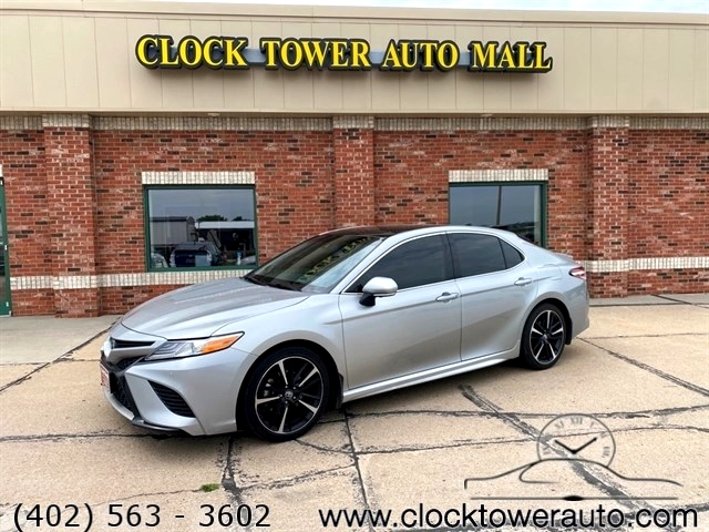 Customer signing paperwork for new car purchase